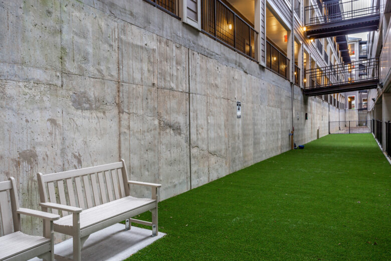 grassy pathway with white benches